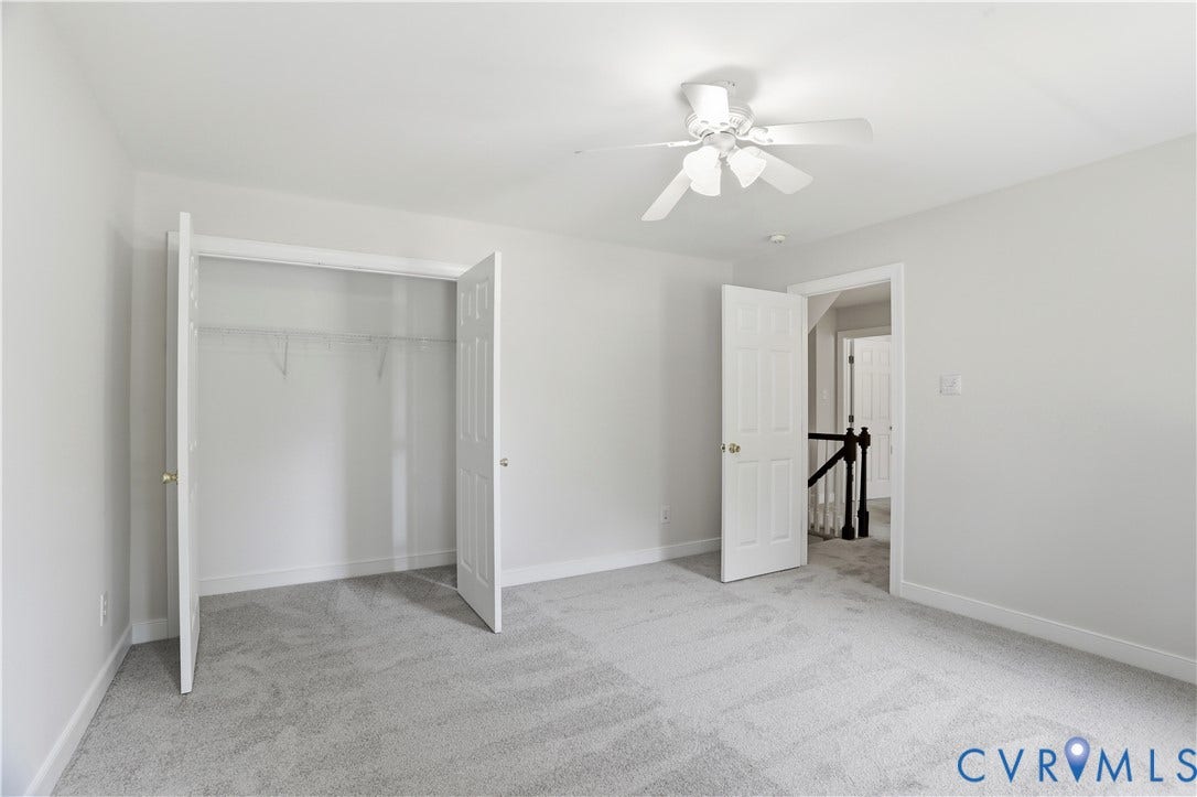 10721 Sheppards Way Drive, Sheppards Way, Glen Allen, VA 23060 Light gray wall-to-wall carpeting, white ceiling fan with light fixture, white interior doors, and a built-in closet with bi-fold doors and wire shelving