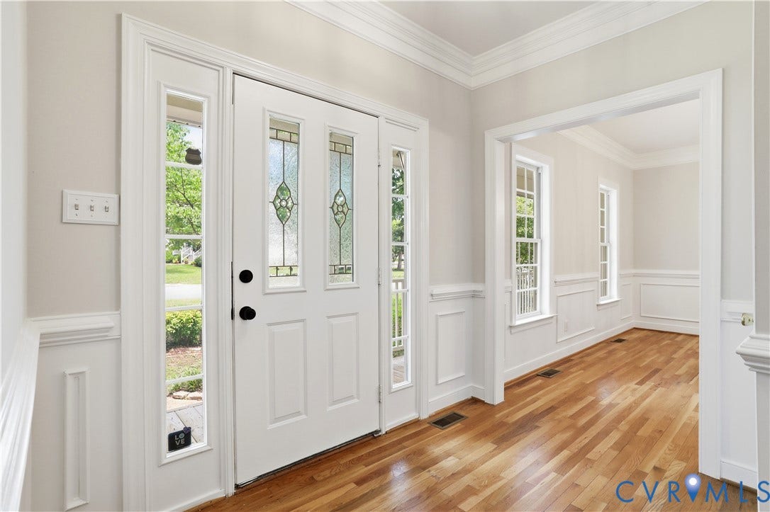 10721 Sheppards Way Drive, Sheppards Way, Glen Allen, VA 23060 Elegant foyer showcasing gleaming hardwood flooring, white six-panel entry doors with decorative glass sidelights, and crown molding