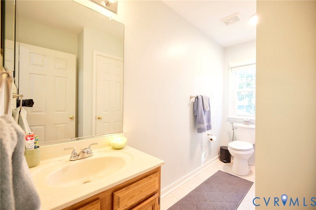 2633 Bradway Lane, Henrico, VA 23233 Integrated vanity with a single basin sink, chrome faucet, and wood-finish cabinetry