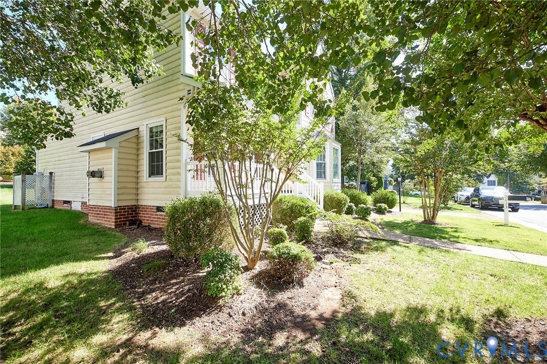 2633 Bradway Lane, Henrico, VA 23233 Siding exterior with a brick foundation, featuring a white window frame and a covered utility area
