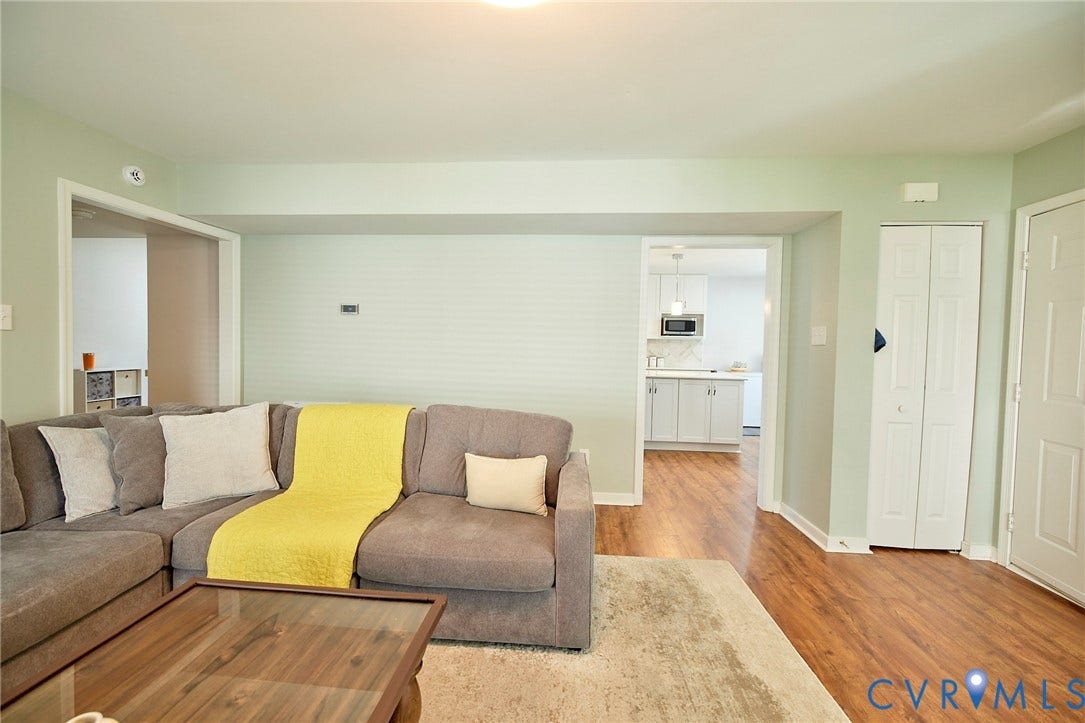 2633 Bradway Lane, Henrico, VA 23233 Wood-finish flooring throughout, with a white bi-fold door and a white entry door