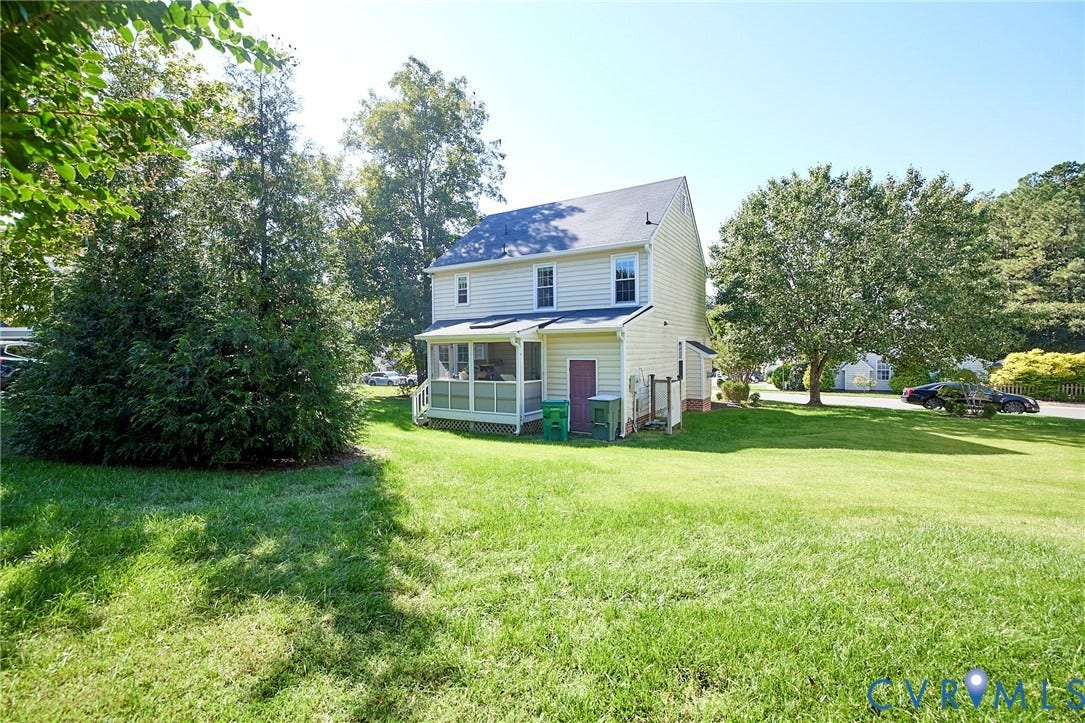 2633 Bradway Lane, Henrico, VA 23233 Expansive rear yard with a manicured lawn, mature trees, and a screened porch
