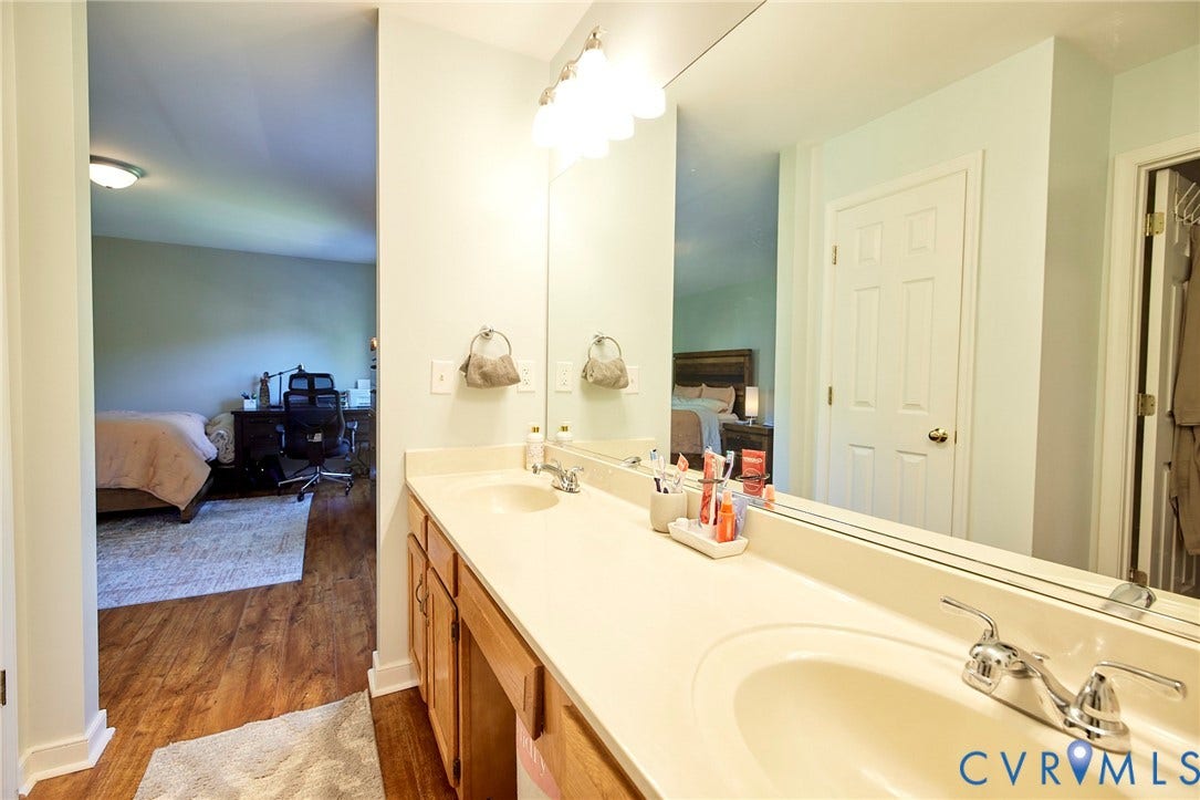 2633 Bradway Lane, Henrico, VA 23233 Dual vanity with undermount sinks, chrome fixtures, and a large wall-mounted mirror