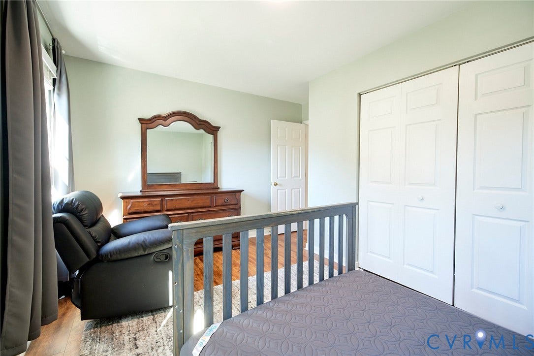 2633 Bradway Lane, Henrico, VA 23233 Wood-finish flooring with light wall tones and white bi-fold closet doors