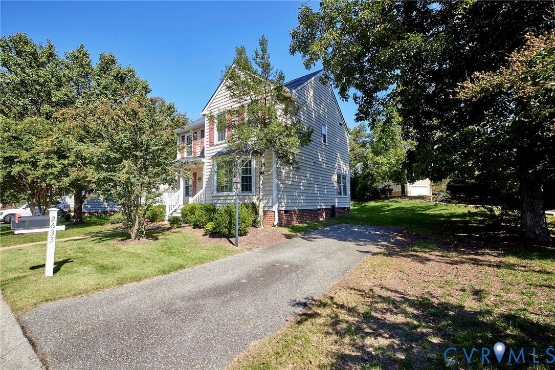 2633 Bradway Lane, Henrico, VA 23233 Classic Colonial residence featuring a gabled roofline and multi-pane windows, set on a landscaped lot with mature trees and a paved driveway approach