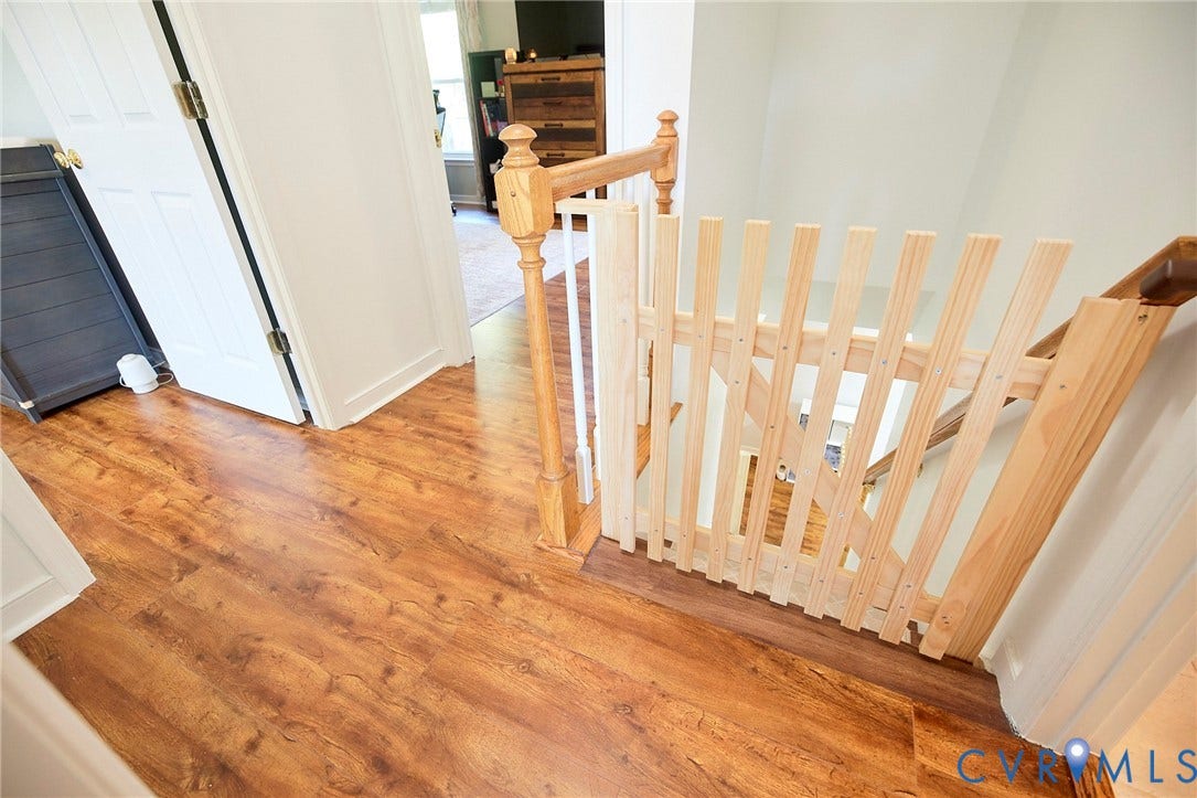 2633 Bradway Lane, Henrico, VA 23233 Wood-finish flooring throughout, white interior doors, and a wood railing with white spindles