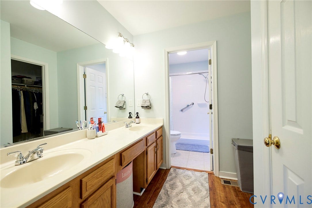 2633 Bradway Lane, Henrico, VA 23233 Double vanity with integrated sinks, chrome fixtures, and natural wood-finish cabinetry