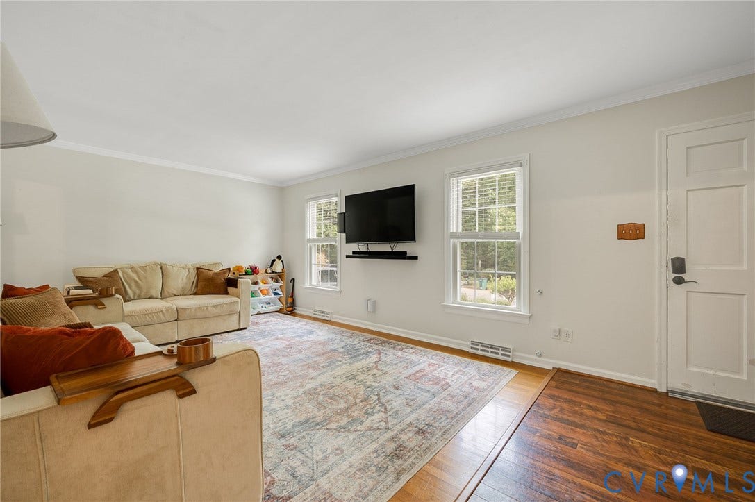 7516 Oakmont Drive, Henrico, VA 23228 Wood-finish flooring, white paneled door, and two double-hung windows