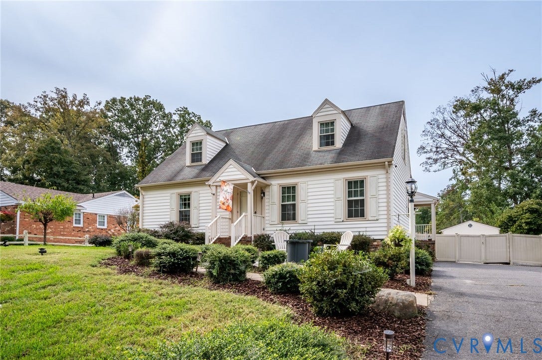 7516 Oakmont Drive, Henrico, VA 23228 Siding exterior with a dark roof, featuring multiple dormer windows and decorative shutters