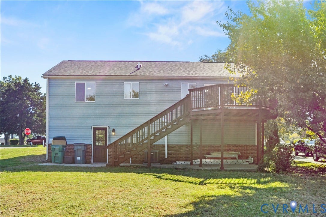 2836 Neale Street, 5-040, Henrico, VA 23223 Rear exterior featuring light blue siding, a dark brown deck, and a contrasting dark brown door