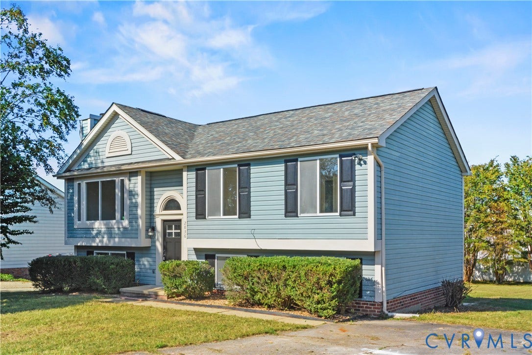 2836 Neale Street, 5-040, Henrico, VA 23223 Light blue siding exterior with dark shutters, featuring a grey shingle roof and an arched entryway
