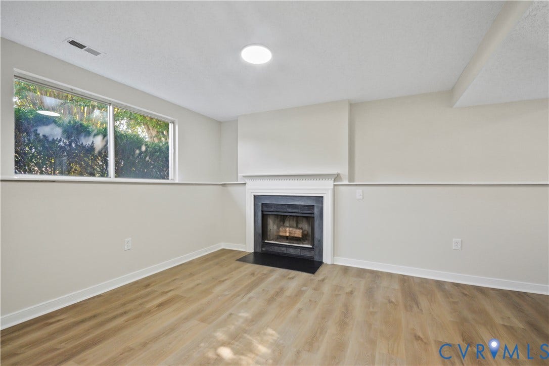 2836 Neale Street, 5-040, Henrico, VA 23223 Fireplace with mantel, wood-finish flooring, recessed lighting, and a large window