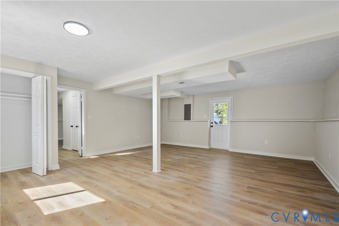 2836 Neale Street, 5-040, Henrico, VA 23223 Expansive room featuring wood-finish flooring, recessed lighting, and a white paneled door