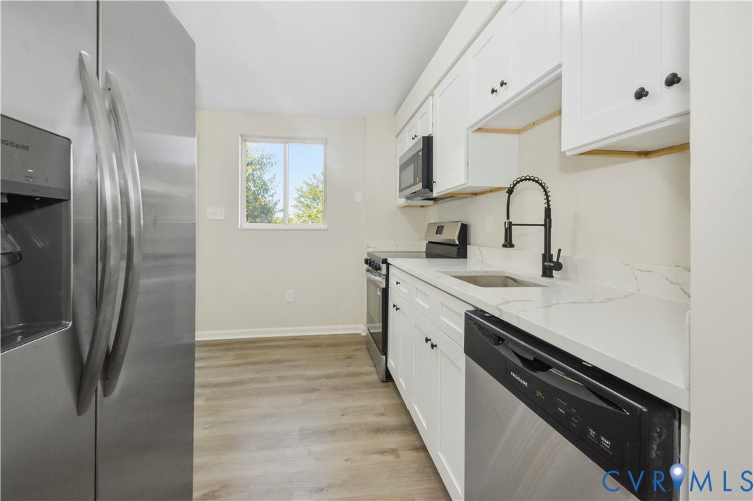 2836 Neale Street, 5-040, Henrico, VA 23223 White cabinetry with black hardware, stainless steel refrigerator, white countertops, wood-finish flooring, and a stainless steel dishwasher