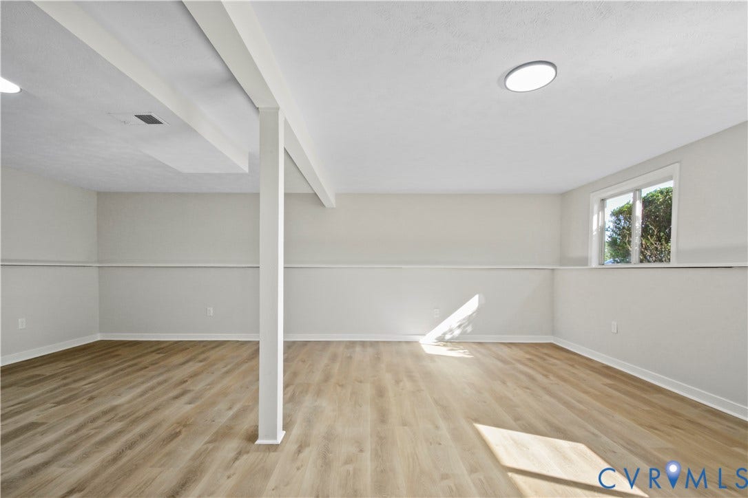2836 Neale Street, 5-040, Henrico, VA 23223 Spacious room featuring wood-finish flooring, white walls, exposed ceiling beams, and recessed lighting