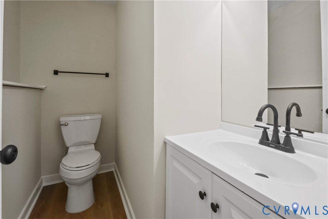 2836 Neale Street, 5-040, Henrico, VA 23223 White vanity with integrated sink, matte black faucet, and wood-finish flooring