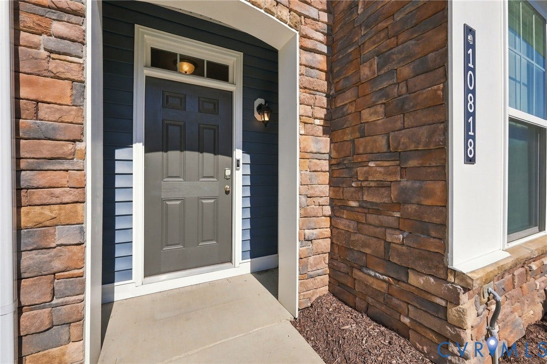 10818 Ashton Poole Place, Henrico, VA 23059 Stone veneer exterior with a concrete entryway, panel-style front door, and transom window