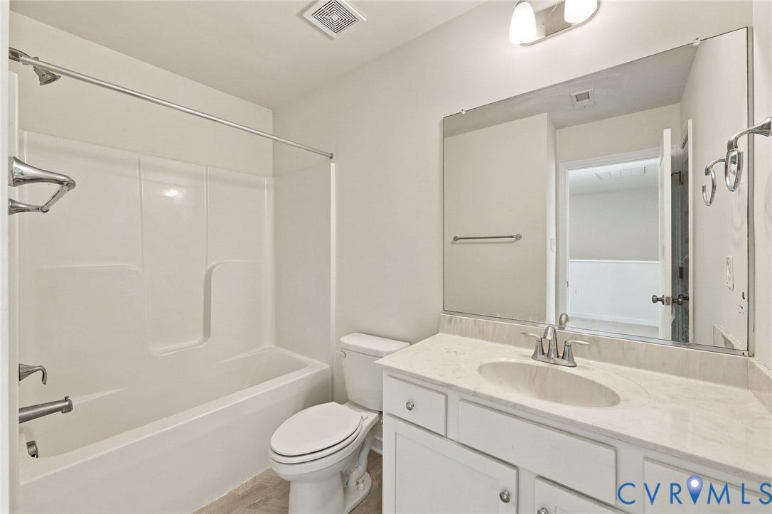 10818 Ashton Poole Place, Henrico, VA 23059 White tub/shower combination, single vanity with light-colored countertop, and a large wall-mounted mirror