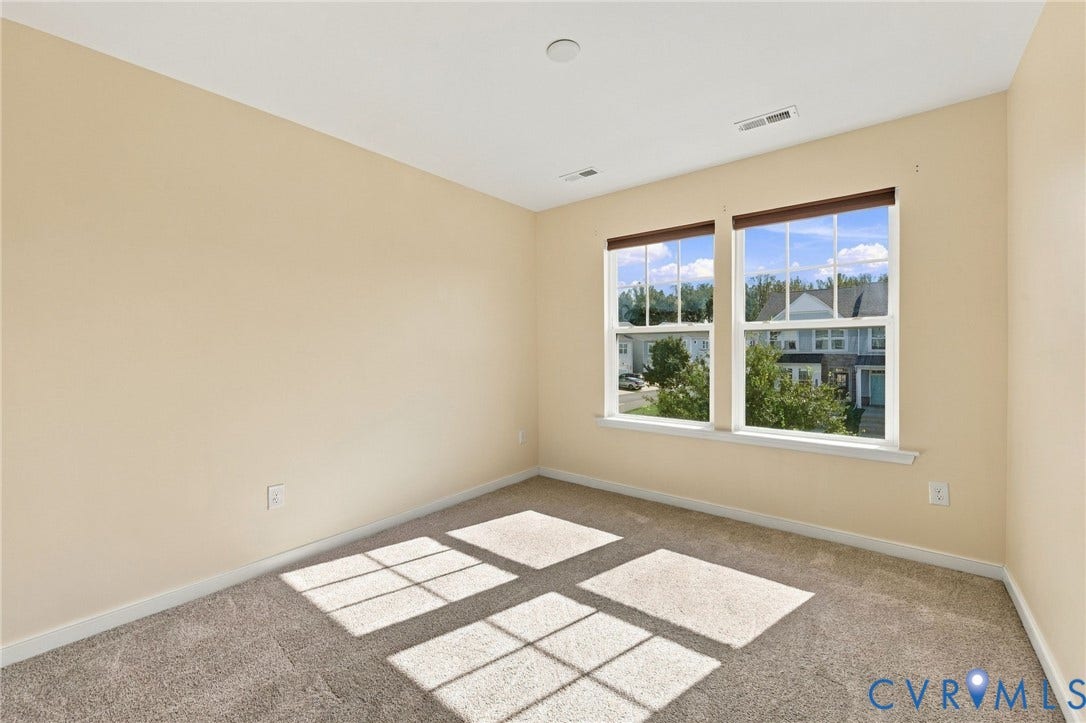 10818 Ashton Poole Place, Henrico, VA 23059 Neutral-toned walls, carpet flooring, and two double-hung windows with blinds