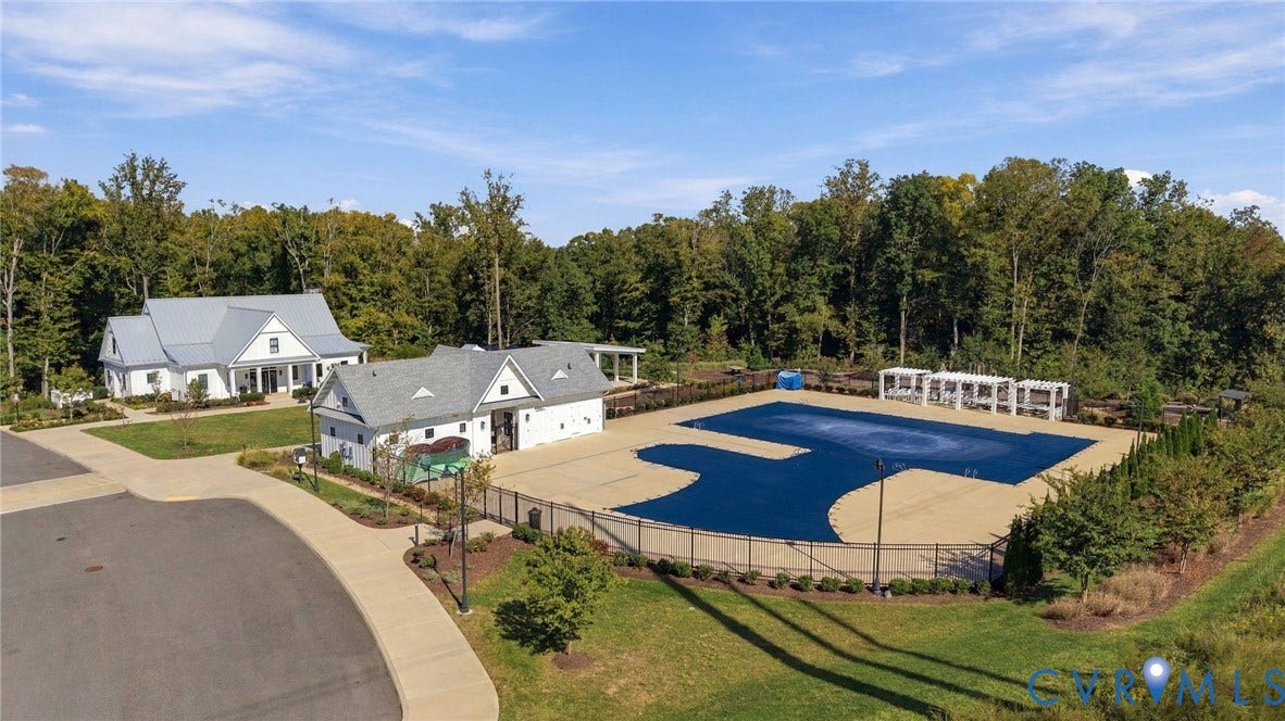 10818 Ashton Poole Place, Henrico, VA 23059 Community clubhouse with covered porch, adjacent pool house, and fenced pool area with cabanas