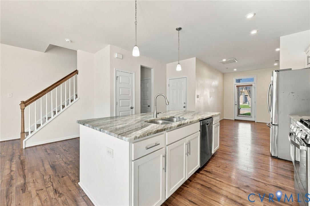10818 Ashton Poole Place, Henrico, VA 23059 Kitchen island with a double basin sink, stainless steel dishwasher, and pendant lighting