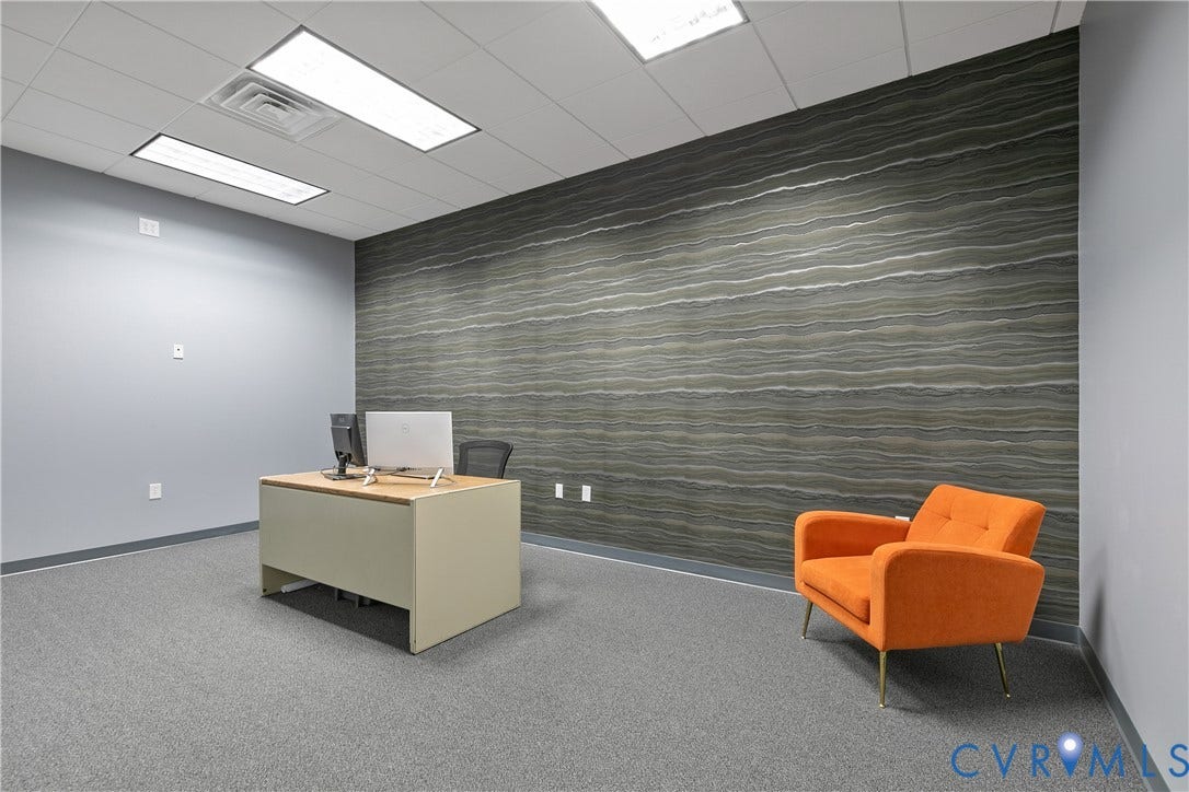 2575 Homeview Drive, Henrico, VA 23294 Textured accent wall, drop ceiling with integrated lighting, gray carpeted flooring, and light gray painted walls