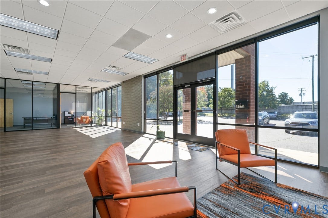 2575 Homeview Drive, Henrico, VA 23294 Expansive commercial interior with wood-finish flooring, full-height exterior windows, and a drop ceiling with integrated lighting
