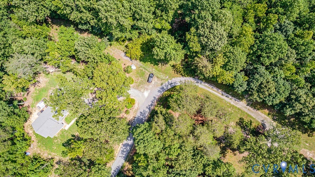 01 Chimney Springs Drive, Hadensville, Goochland, VA 23063 Wooded setting with a gravel driveway, surrounded by mature trees