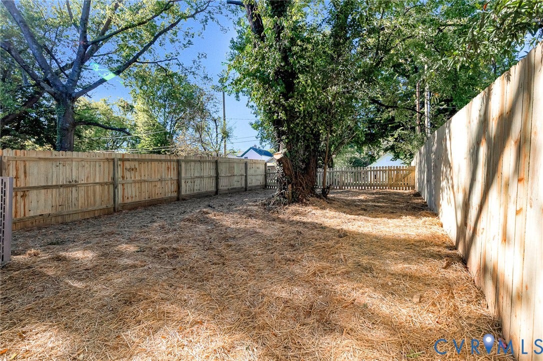 1807 Gordon Avenue, Oak Grove, Oak Grove, VA 23224 Fenced backyard area featuring a mature tree and a wood picket fence