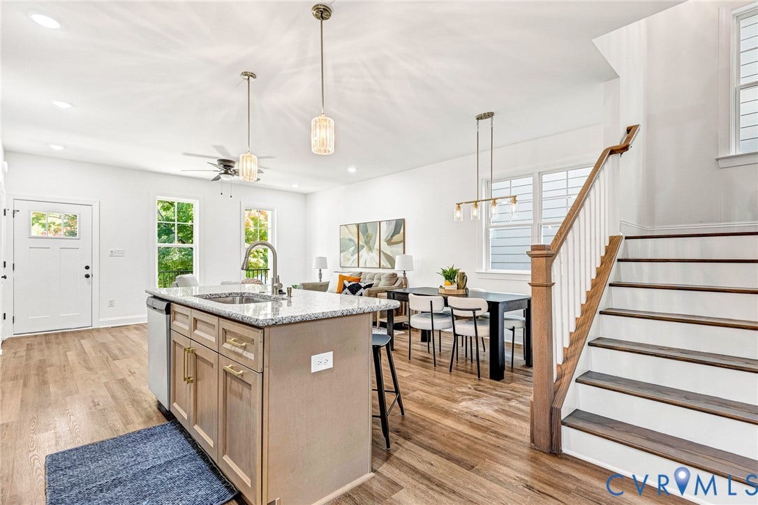 1807 Gordon Avenue, Oak Grove, Oak Grove, VA 23224 Open concept interior featuring wood-finish flooring, a kitchen island with a granite-style countertop, recessed lighting, and a staircase with wood treads and a white balustrade