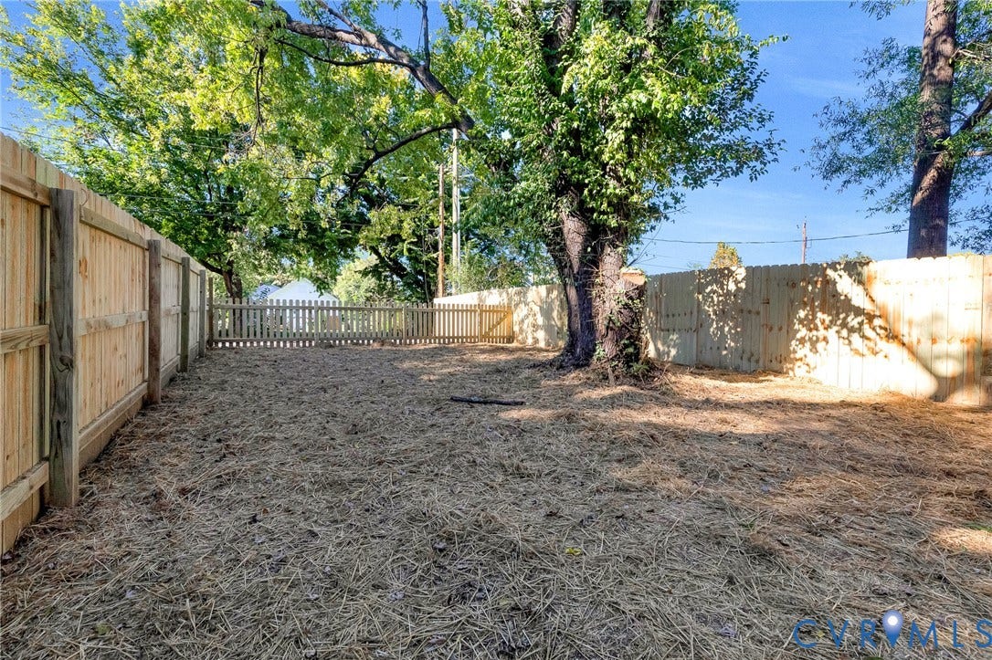 1807 Gordon Avenue, Oak Grove, Oak Grove, VA 23224 Fenced backyard featuring mature trees and a private wood fence