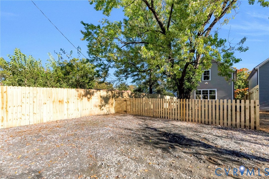 1807 Gordon Avenue, Oak Grove, Oak Grove, VA 23224 Gravel lot with wood privacy fencing and a picket fence section