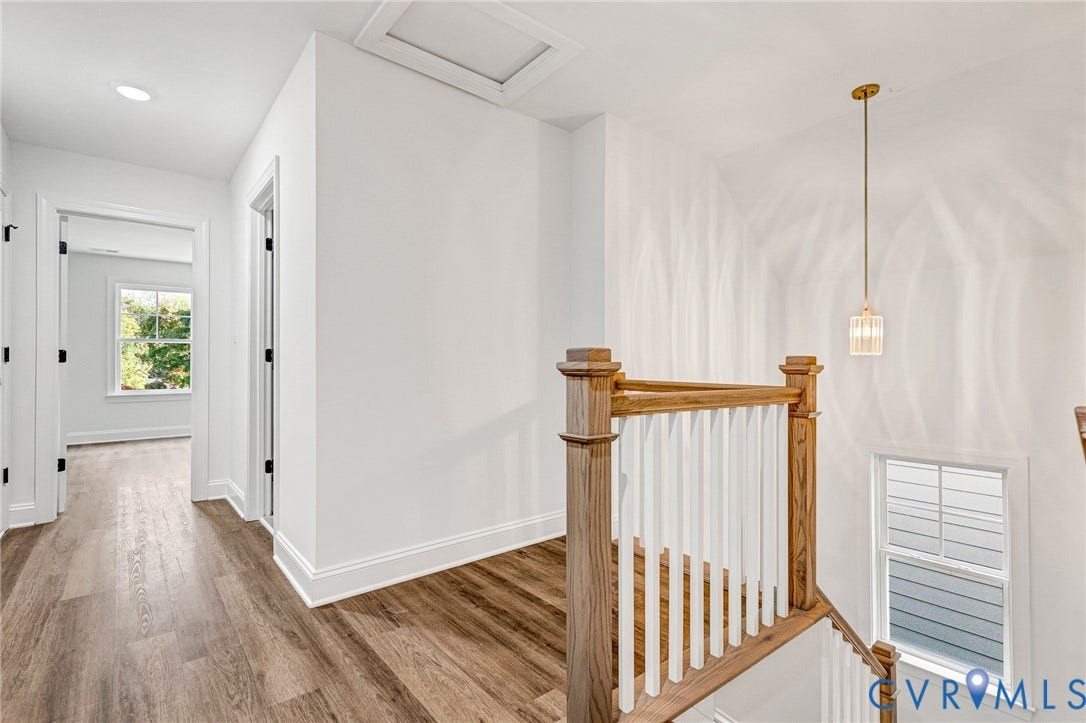 1807 Gordon Avenue, Oak Grove, Oak Grove, VA 23224 Wood-finish flooring, white walls, recessed ceiling lighting, and a modern pendant light fixture