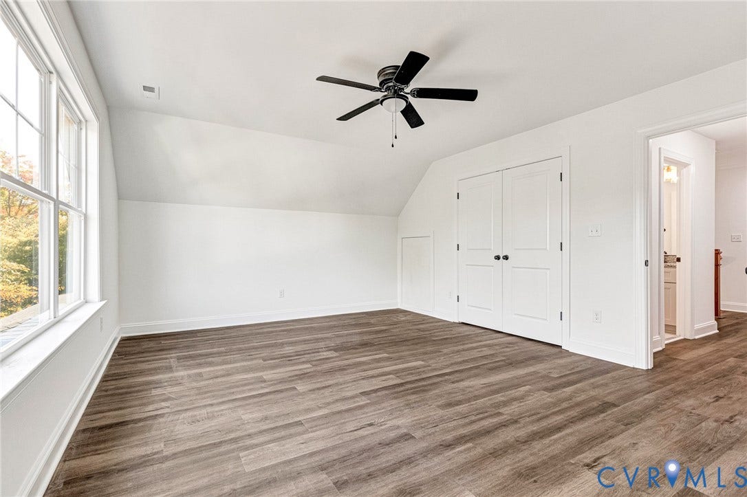 1807 Gordon Avenue, Oak Grove, Oak Grove, VA 23224 Wood-finish flooring, white walls, black ceiling fan, multiple pane window, and built-in closet with white doors