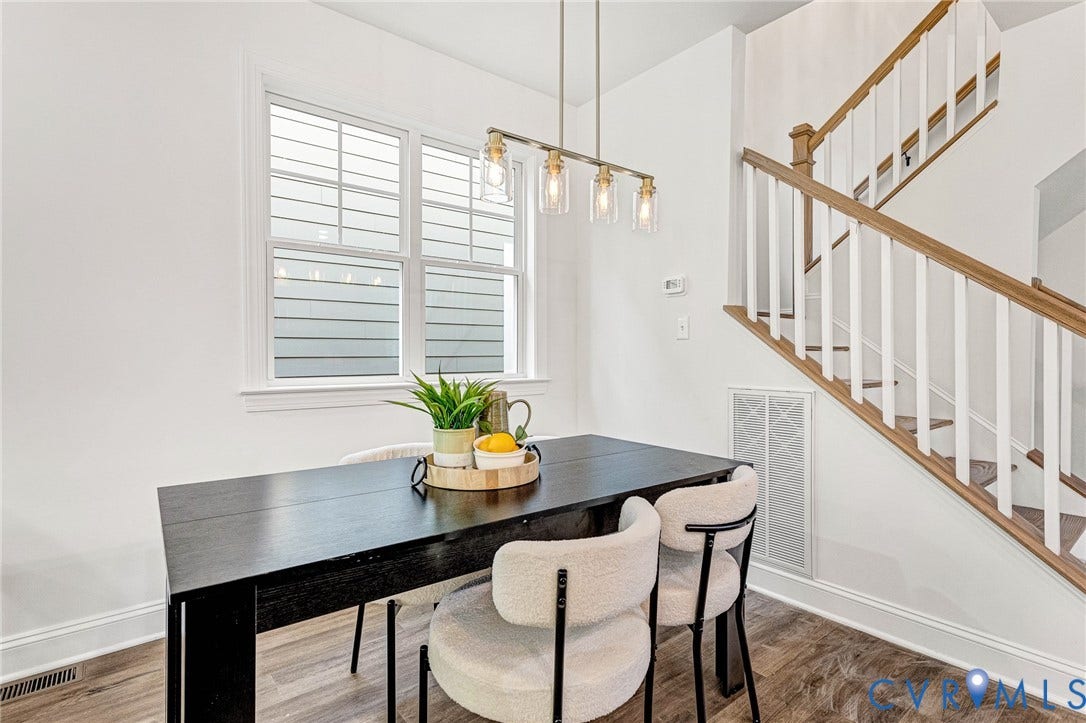1807 Gordon Avenue, Oak Grove, Oak Grove, VA 23224 Staircase with wood handrails and white balusters, wood-finish flooring, and a multi-pane window