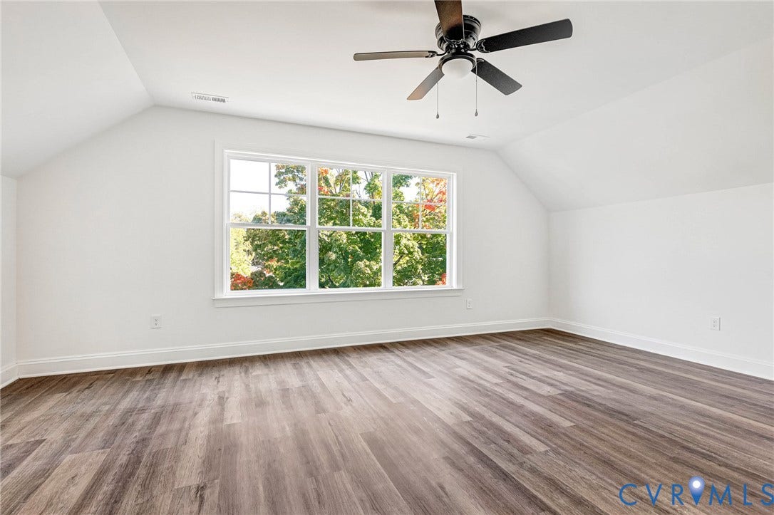 1807 Gordon Avenue, Oak Grove, Oak Grove, VA 23224 Wood-finish flooring, white walls, white trim, multi-pane window, and a ceiling fan with integrated lighting