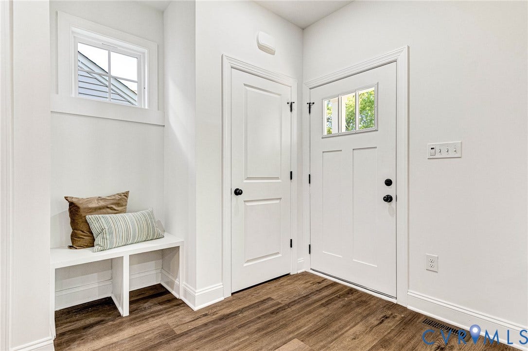 1807 Gordon Avenue, Oak Grove, Oak Grove, VA 23224 Entryway featuring wood-finish flooring, a built-in bench, an overhead window, a solid panel interior door, and an exterior door with lites