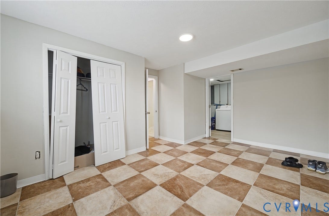 Checkered tile flooring, bi-fold closet doors, recessed lighting, and a neutral wall color