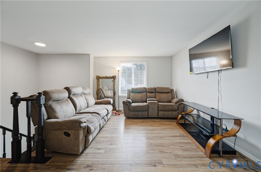 Recessed lighting, wood-finish flooring, white walls, and a window with white trim