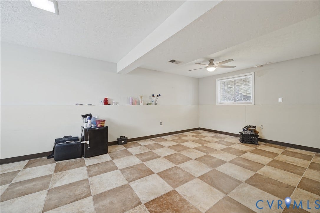 Recessed lighting, ceiling fan, checkered flooring, white trim window, painted walls