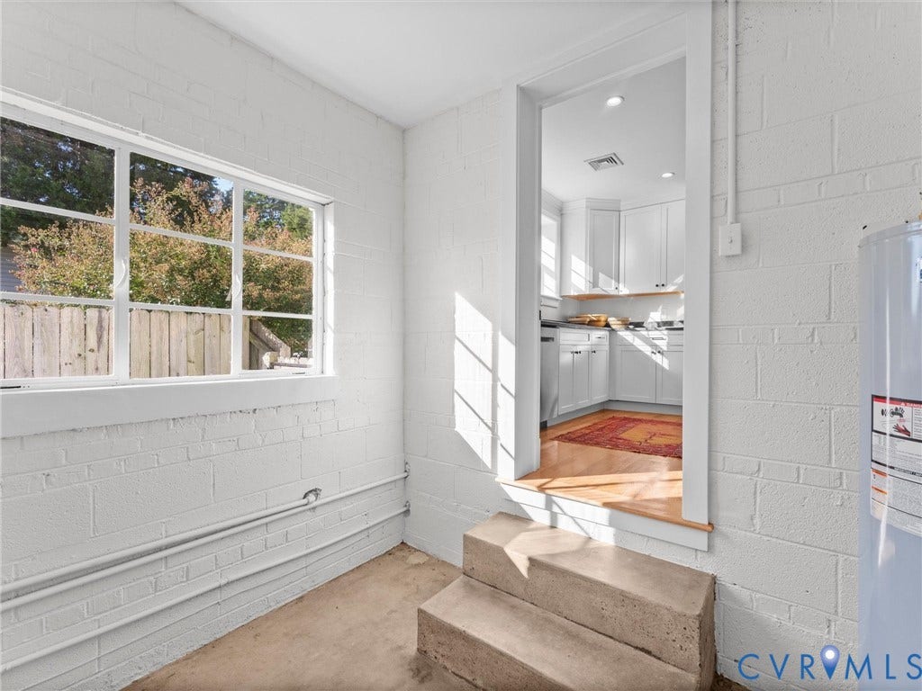 White-painted cinder block walls and a multi-pane window