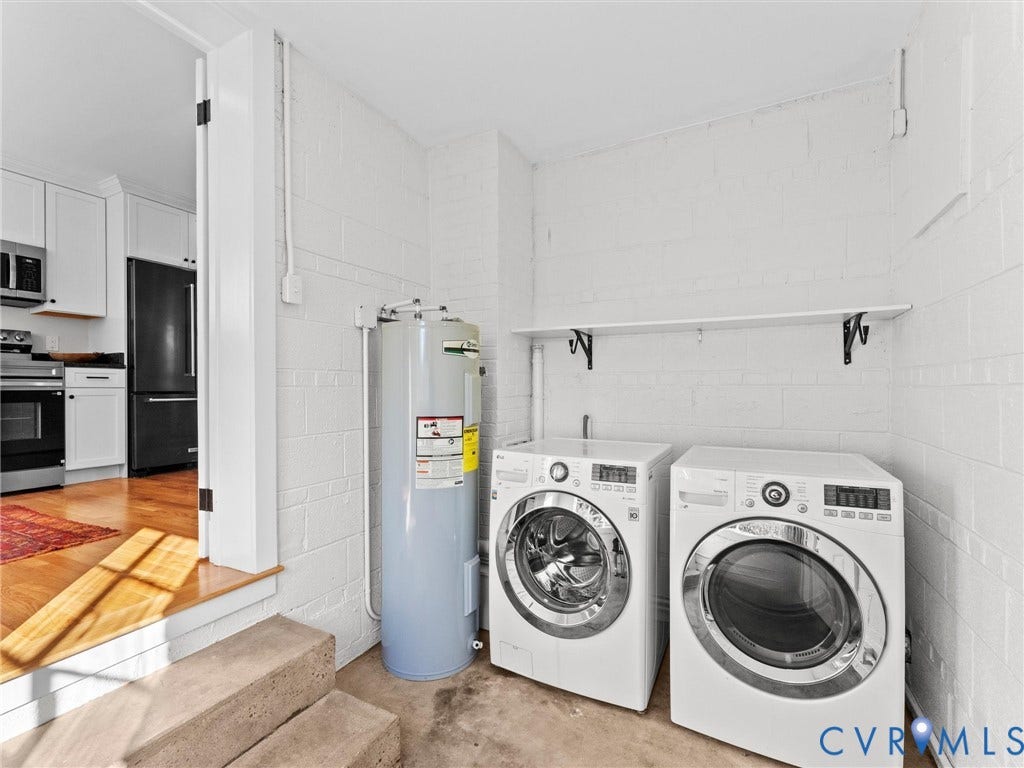 Utility area featuring a water heater, washer, and dryer