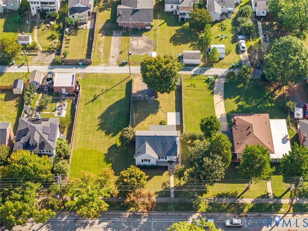 Expansive lot featuring a residential structure and mature trees