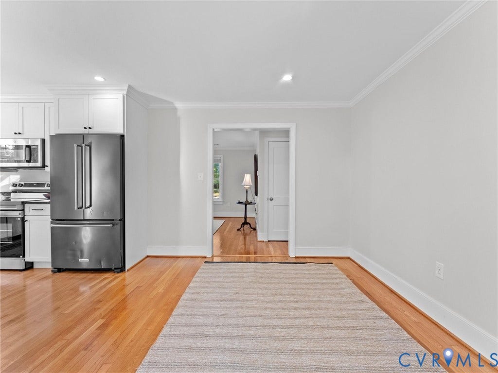 Wood-finish flooring, recessed lighting, and crown molding