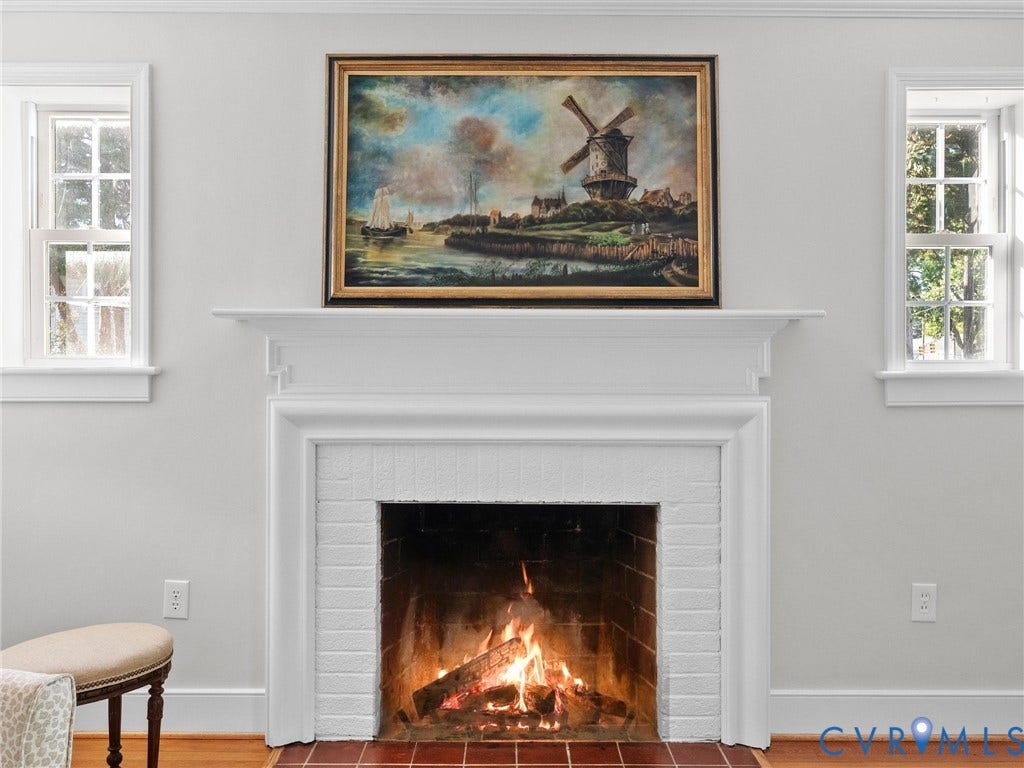 Fireplace featuring a classic white mantel, white painted brick surround, and a terracotta tile hearth