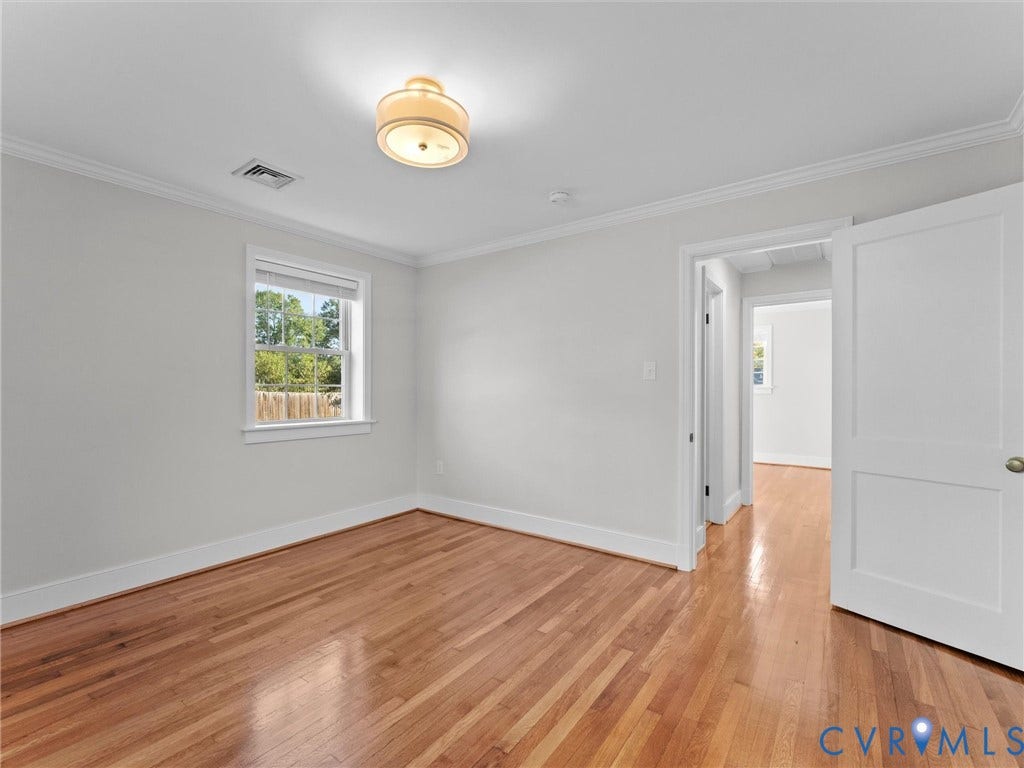 Hardwood flooring, crown molding, white trim, recessed window, and flush mount lighting