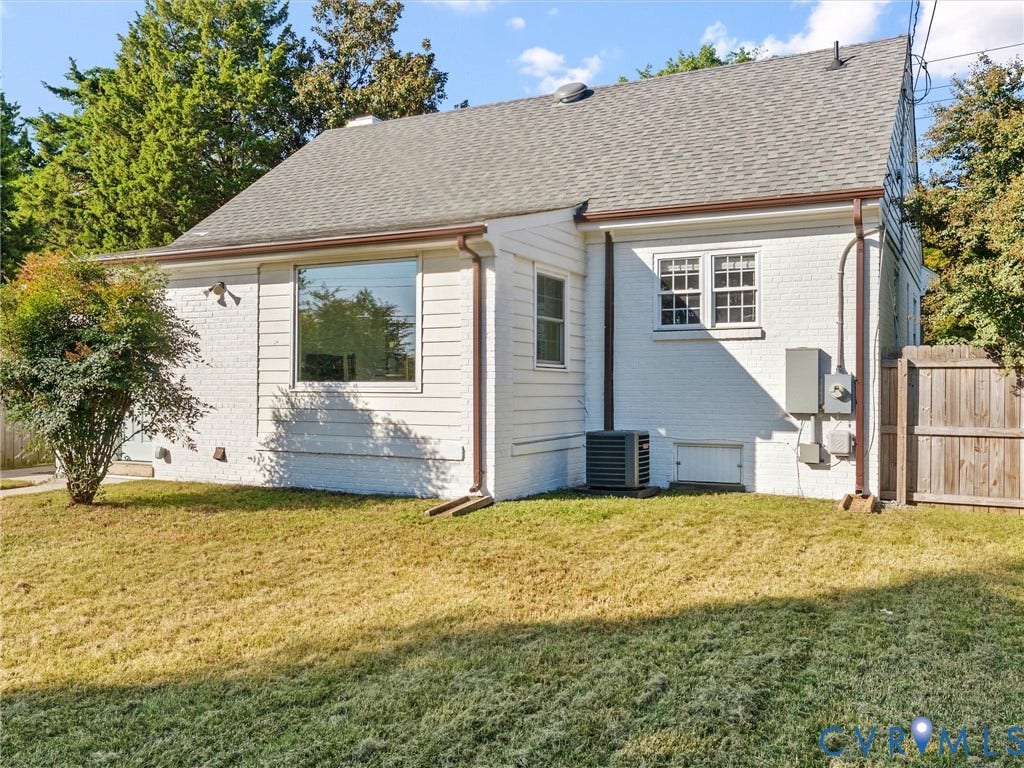White brick and siding exterior with dark brown gutters