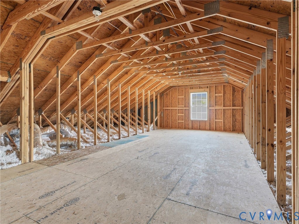 11037 Vogel Court, Bellshire, North Chesterfield, VA 23236 Unfinished attic space featuring exposed wood framing, wood-panel subflooring, and a single pane window