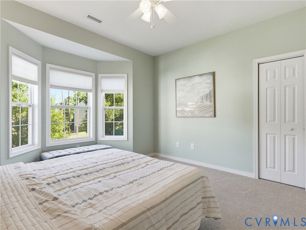 11037 Vogel Court, Bellshire, North Chesterfield, VA 23236 Bay window featuring multiple panels, neutral carpeted flooring, and a ceiling-mounted light fixture with fan