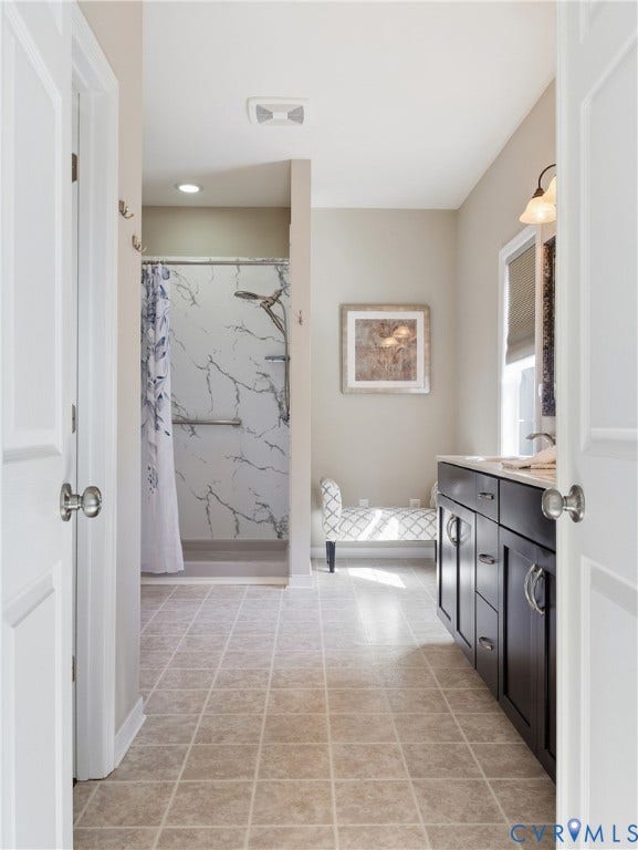 11037 Vogel Court, Bellshire, North Chesterfield, VA 23236 Bathroom featuring dark wood-finish cabinetry, stone-patterned wall surround in the walk-in shower, tile flooring, and wall-mounted vanity lighting